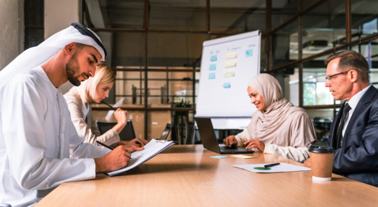 Multiethnic corporate business team meeting in the office for a strategic marketing plan - Office workers, entrepreneurs and company employee at work in a multinational company